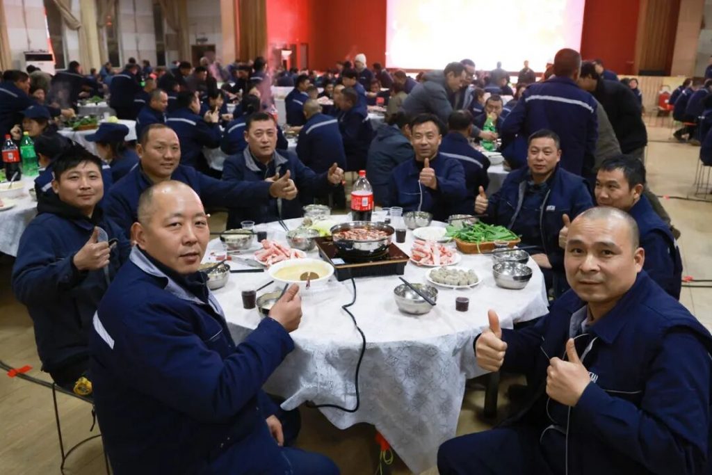 Group of employees dining at a round table