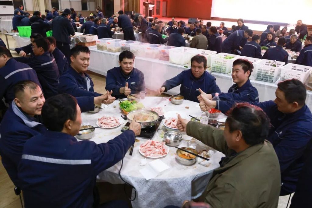 Employees seated together for a shared winter meal