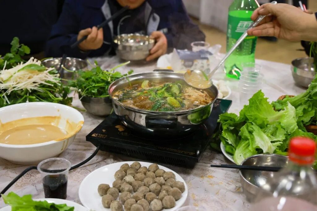 Close view of a hotpot and prepared ingredients