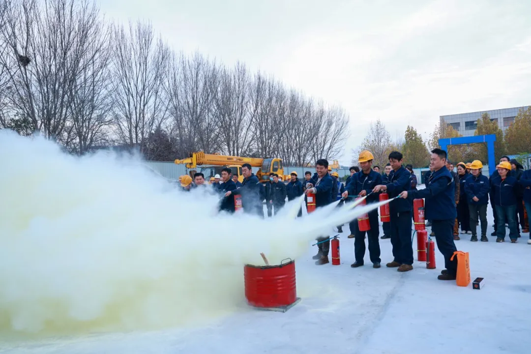 Employees practising extinguisher use outdoors
