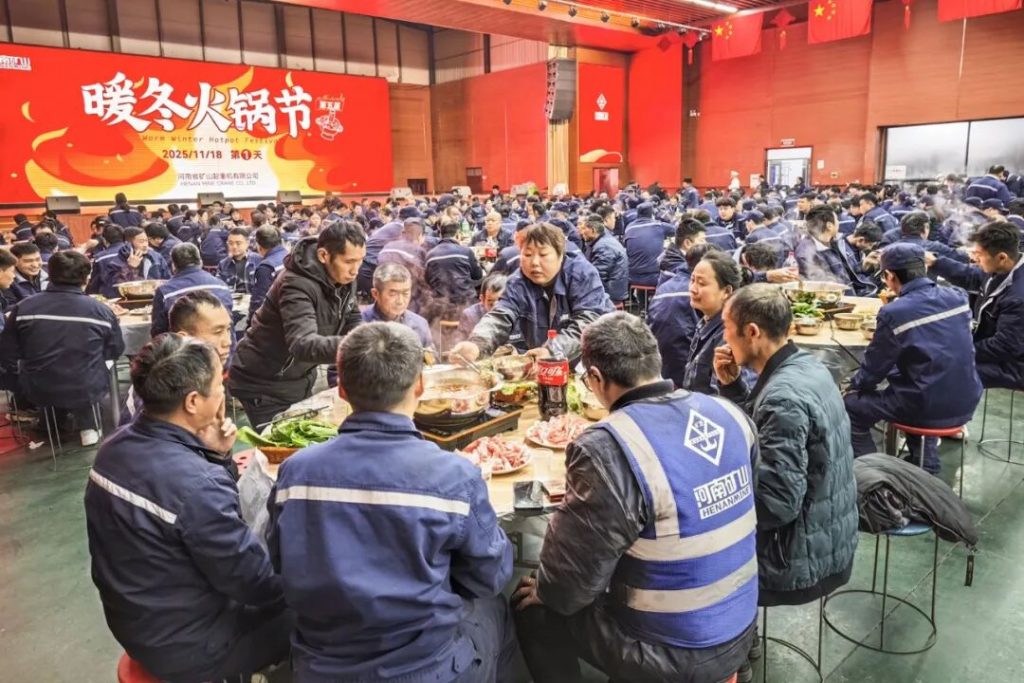 Employees sharing a hotpot meal in a busy dining hall