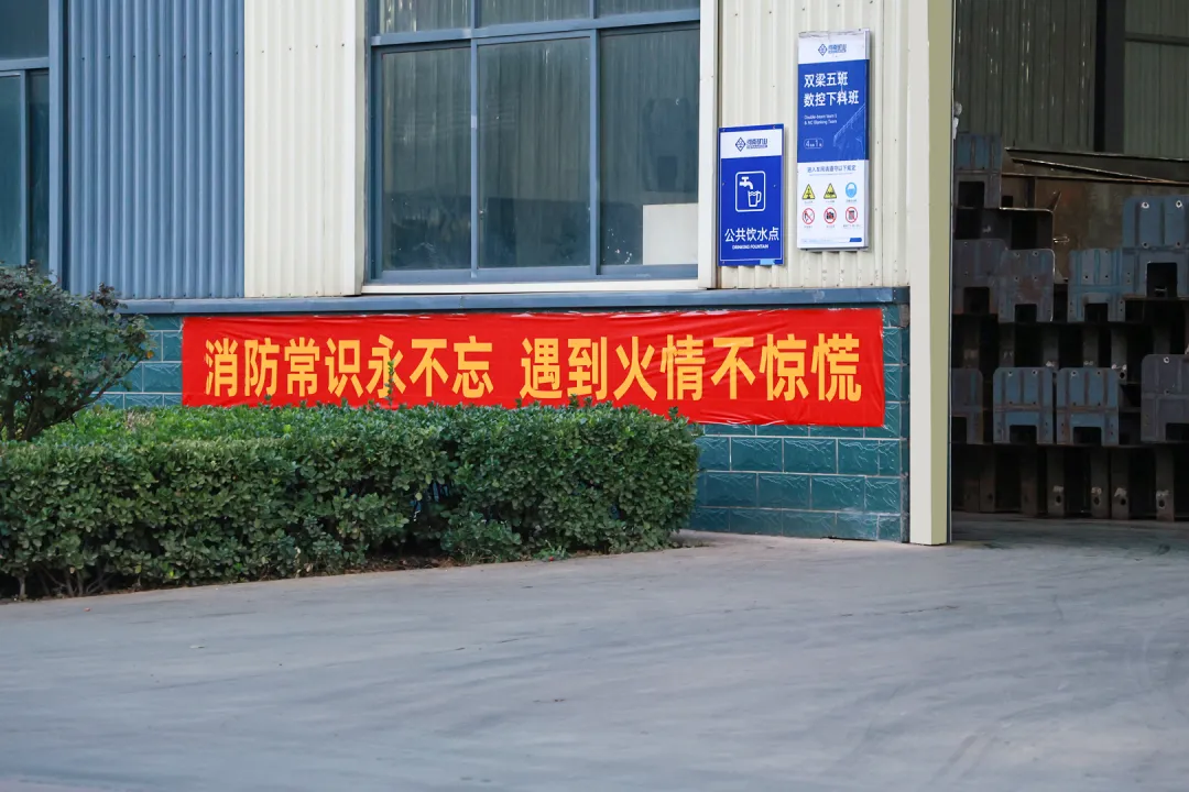 Fire-safety month banner beside a workshop entrance