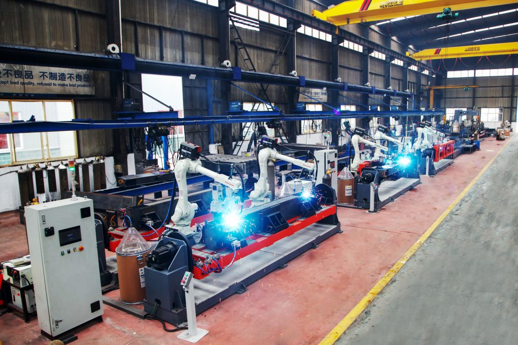 Robotic welding stations operating along a production line