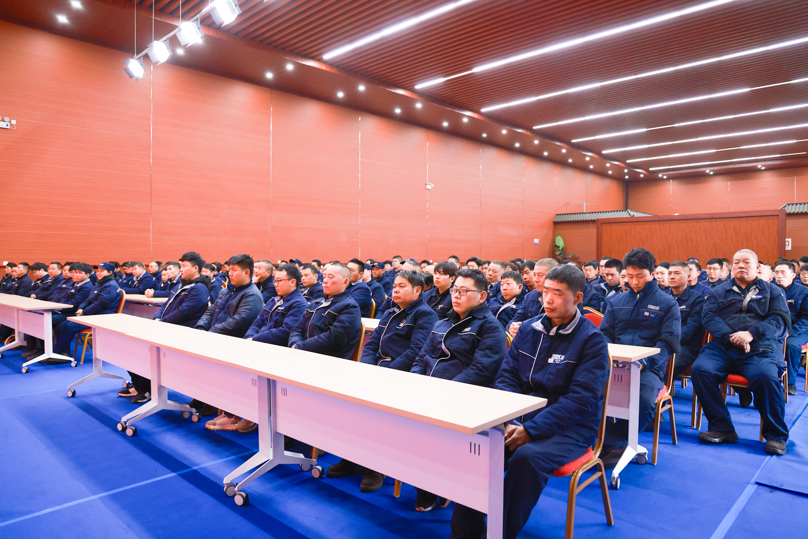 Employees seated at a pre-holiday gathering at Henan Mine Crane before the Lunar New Year