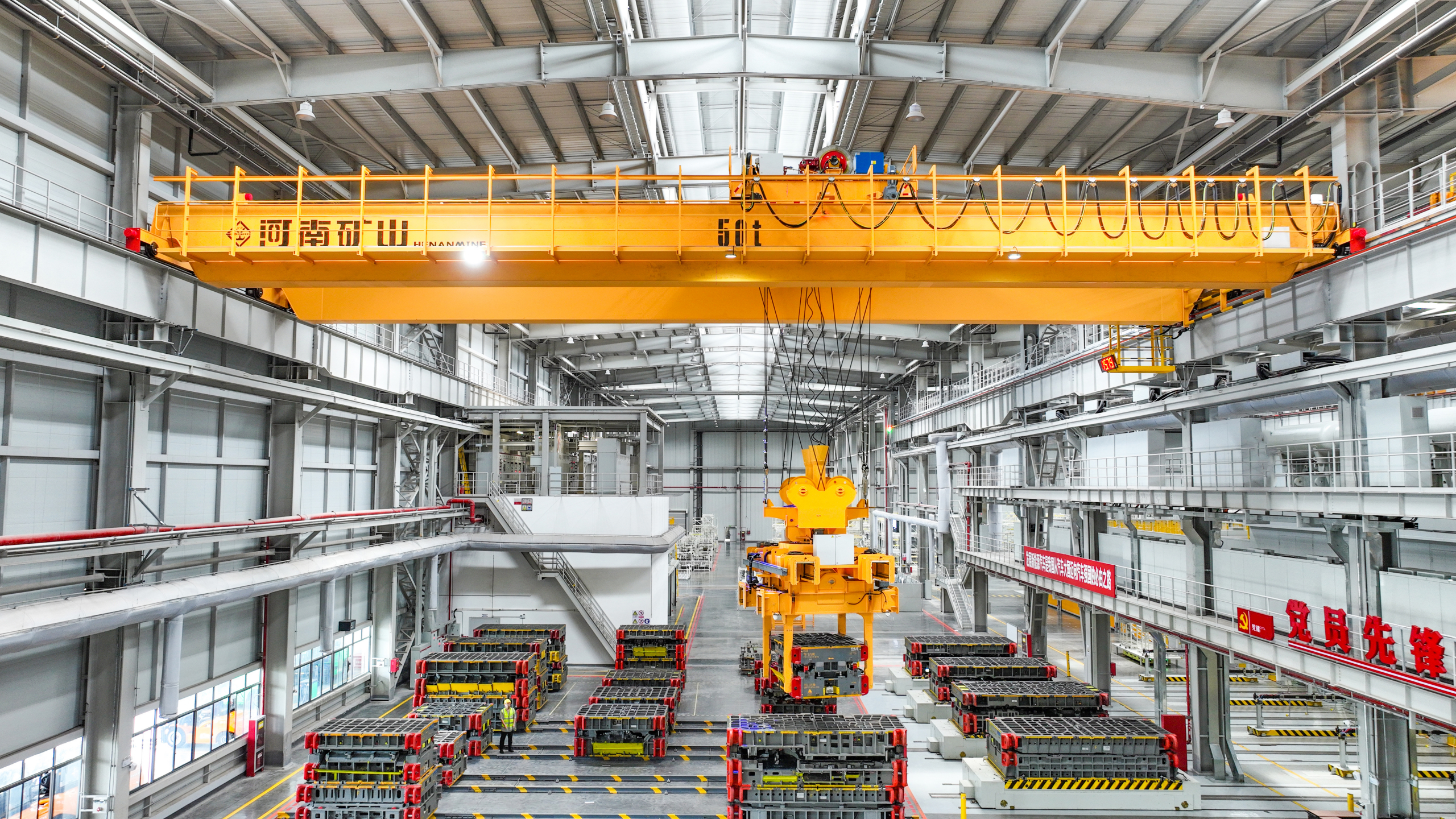 Automated overhead crane above an automotive die storage area