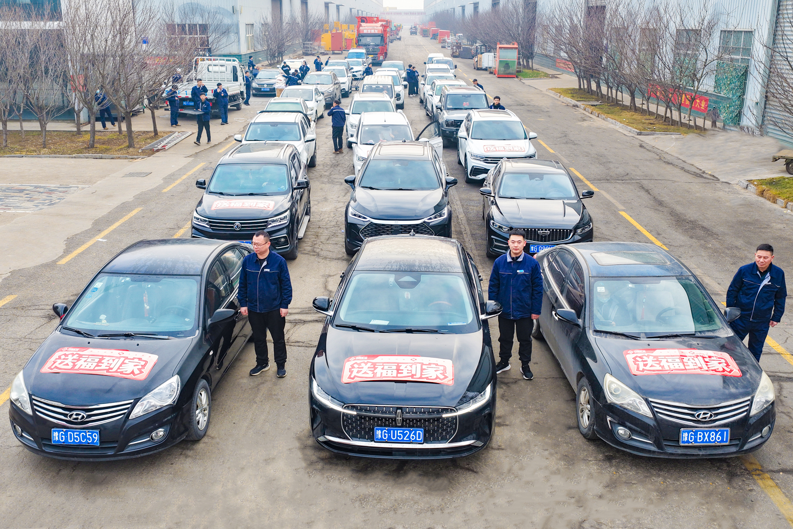 New Year gift-delivery vehicles lined up outside the factory