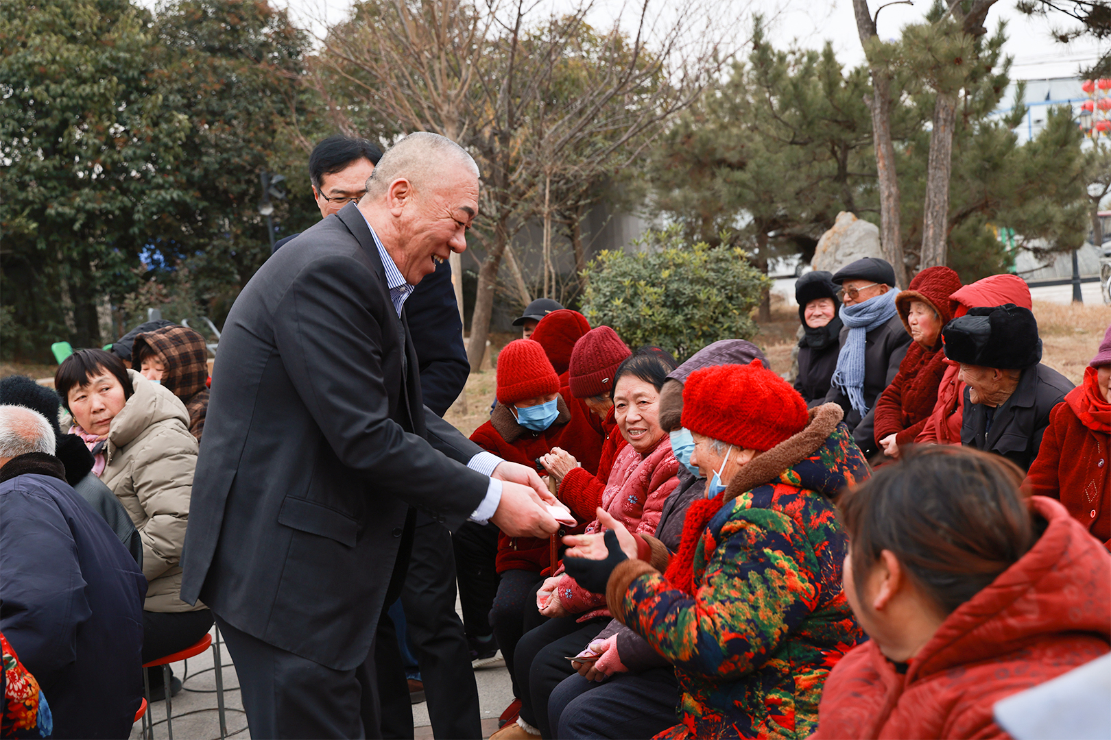 Company representative presenting a seasonal gift to an older resident