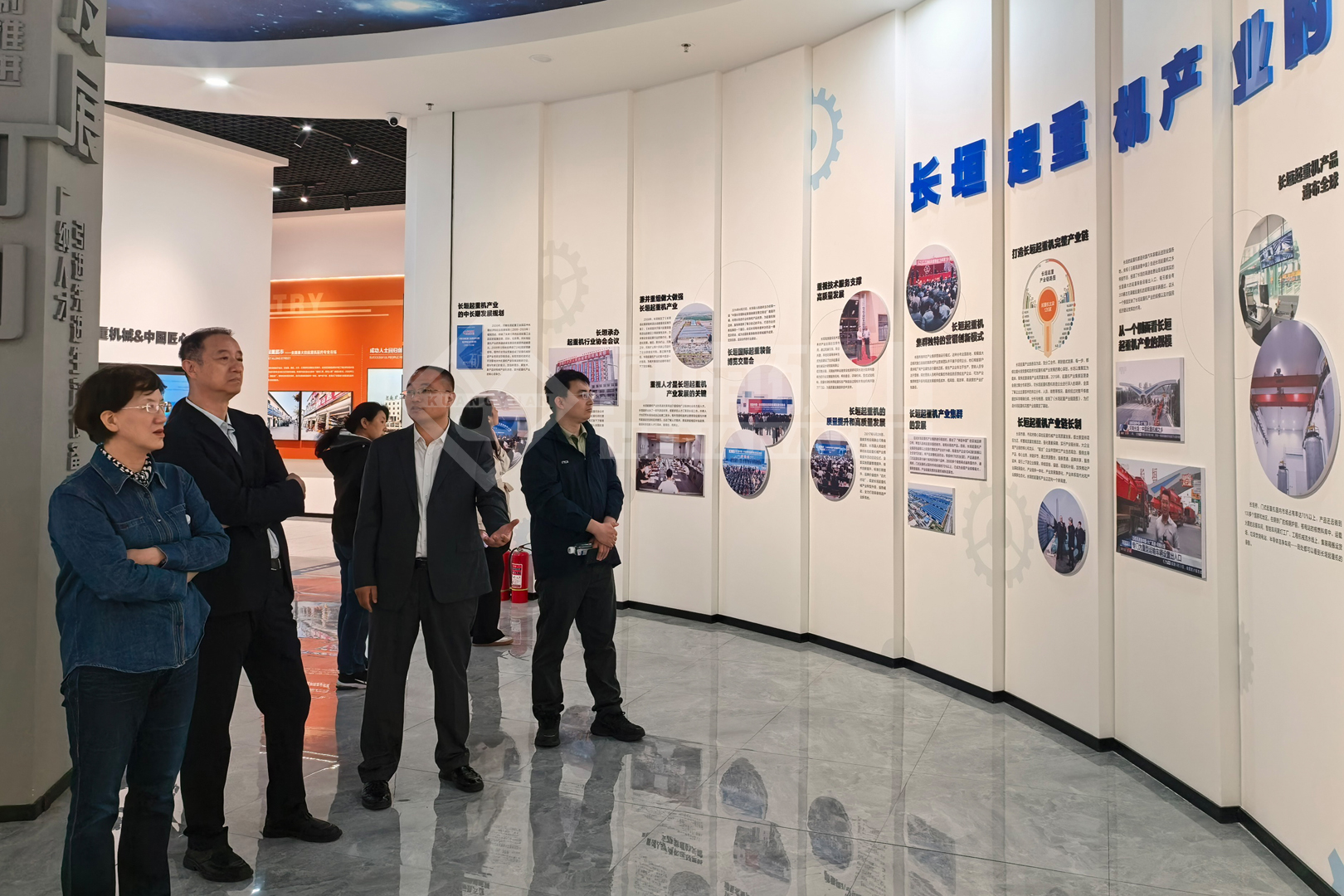 Visitors reviewing the company’s manufacturing information display Visitors reviewing the company’s manufacturing information display
