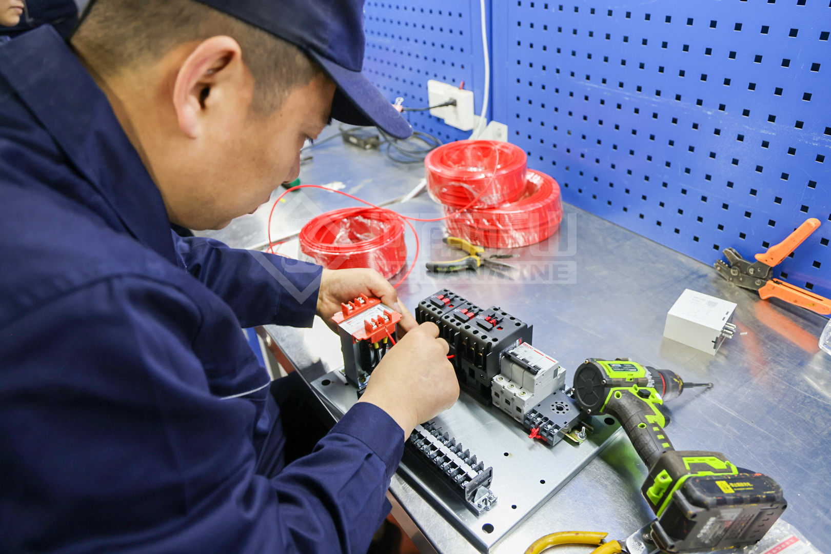 Employee connecting a control panel component