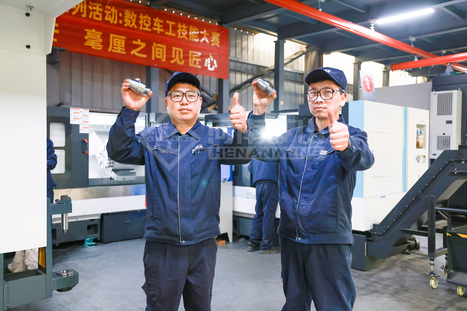 Employees displaying machined test workpieces