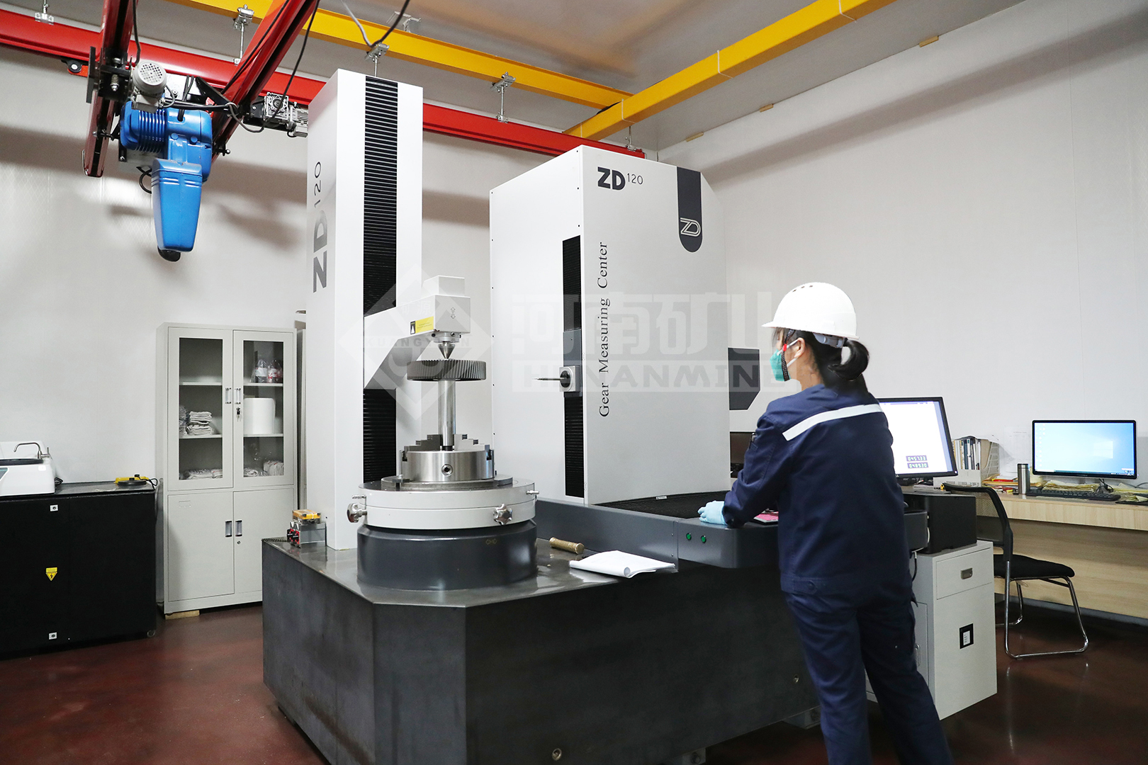 Technician reviewing a component at a measuring machine