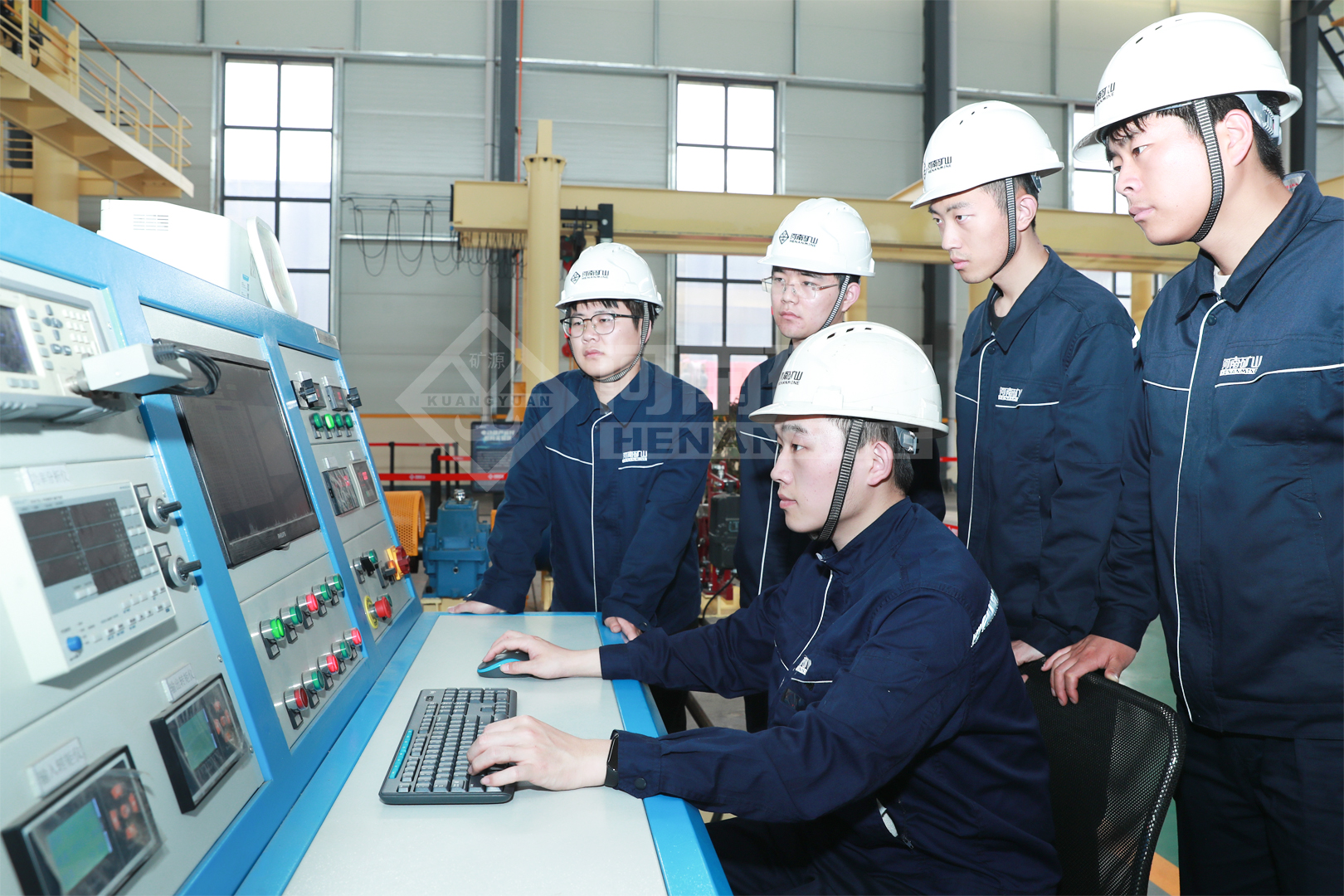 Employees checking production information at a control station
