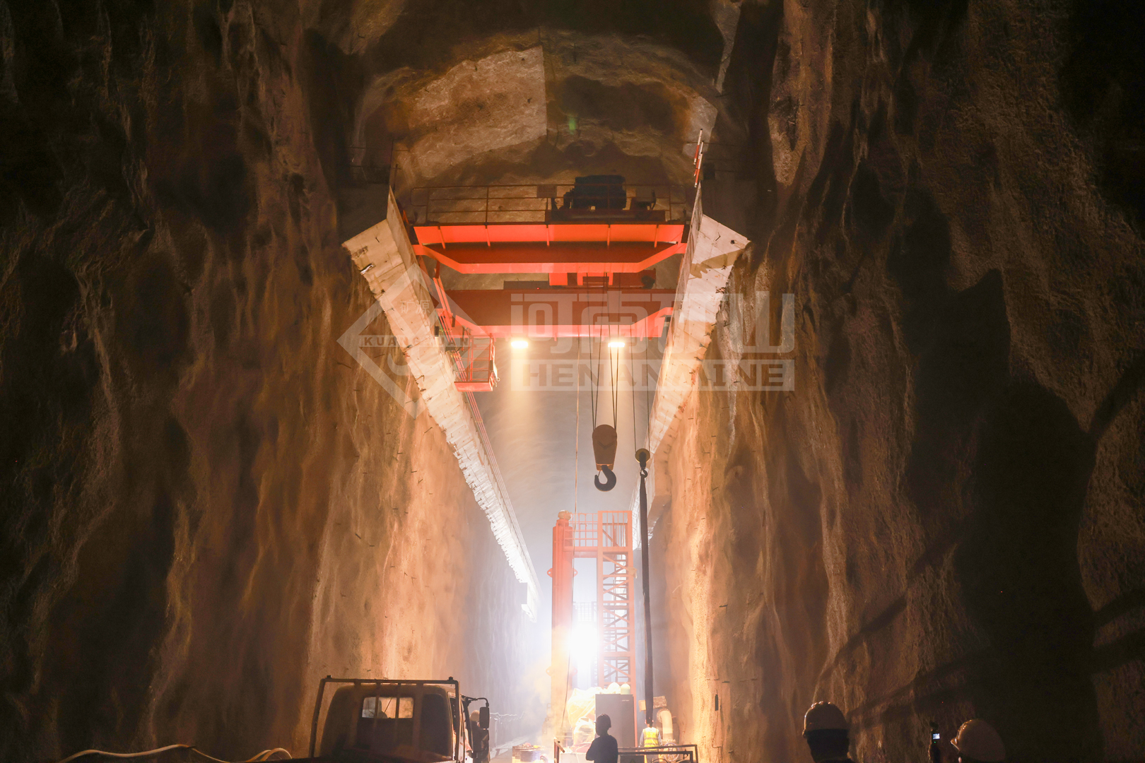 Overhead crane above a deep construction shaft