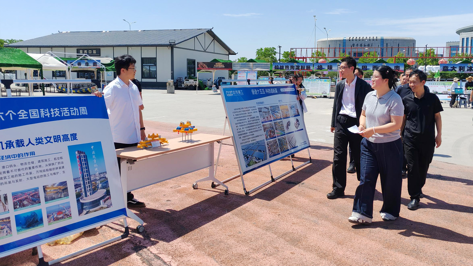 Visitors learning about crane technology at an outdoor display