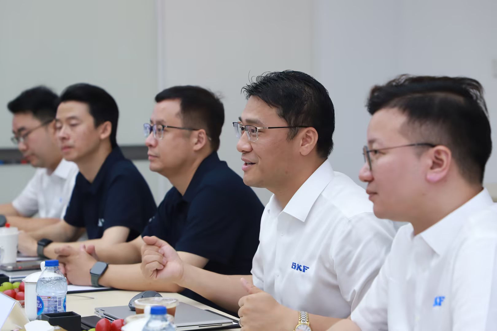 Participants discussing crane components at the conference table