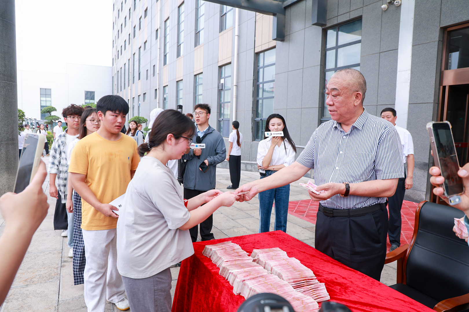 Student receiving a grant beside the distribution table
