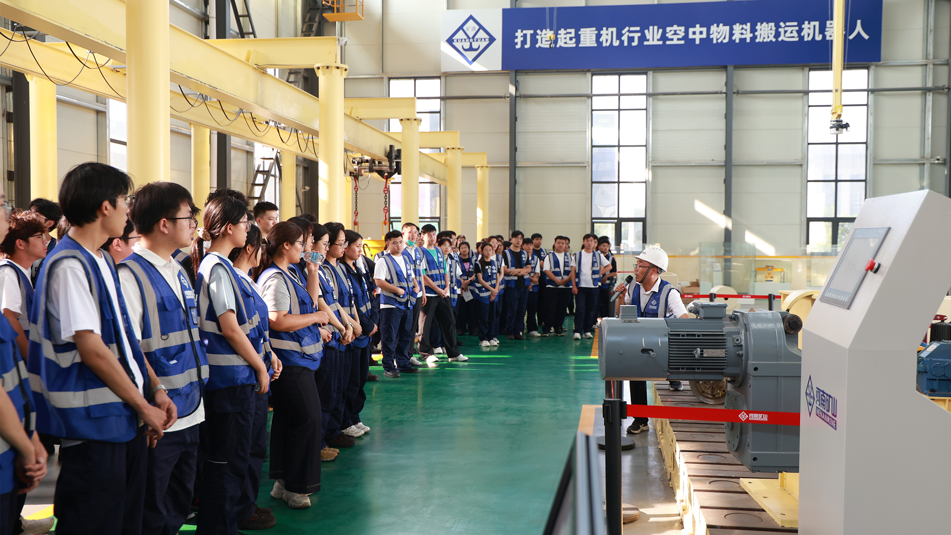 Interns observing equipment in a manufacturing workshop
