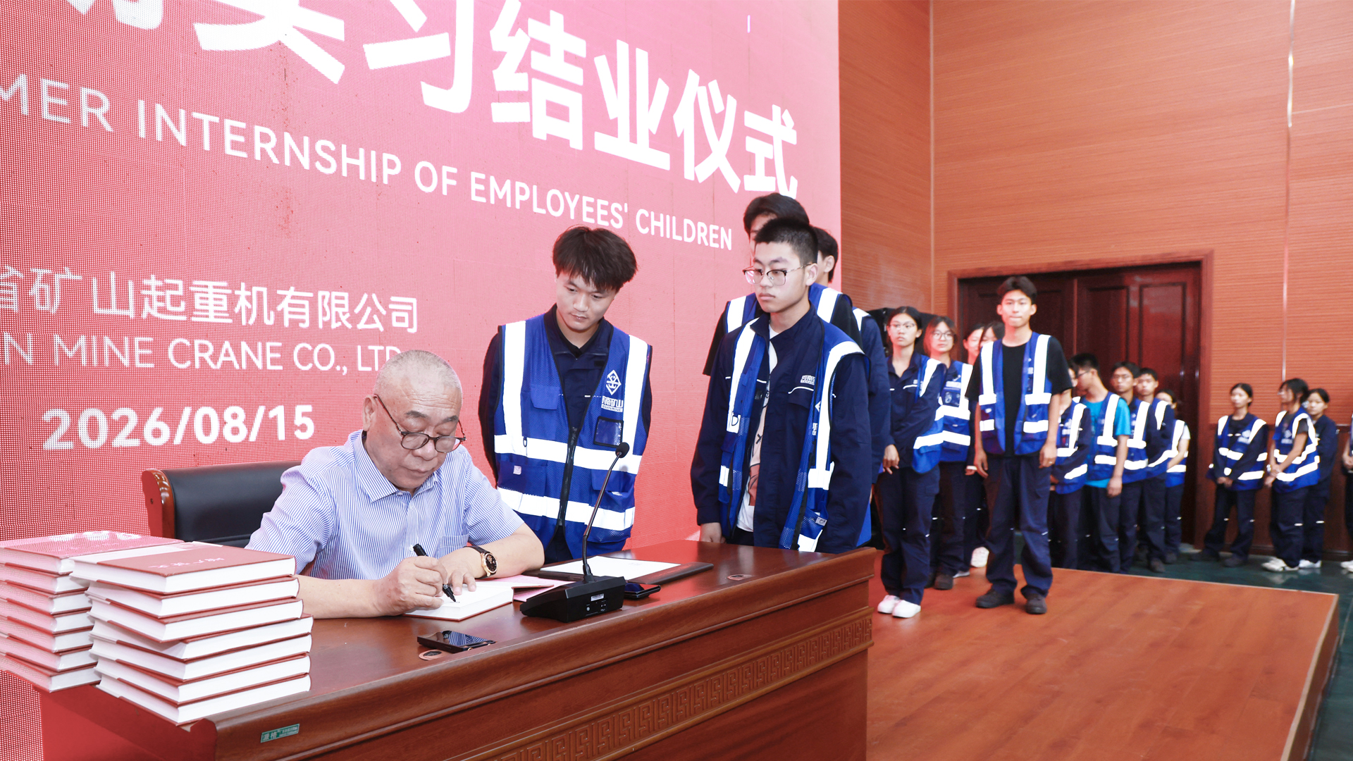 Interns receiving signed books at the closing ceremony