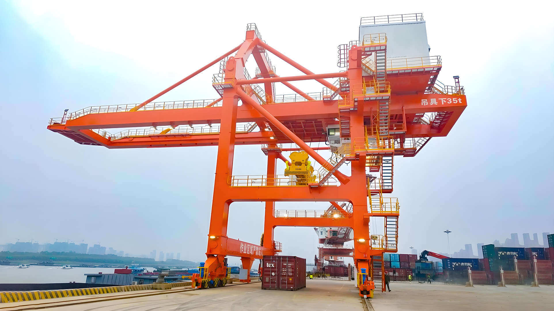 Container handling gantry crane beside a waterside yard Container handling gantry crane beside a waterside yard