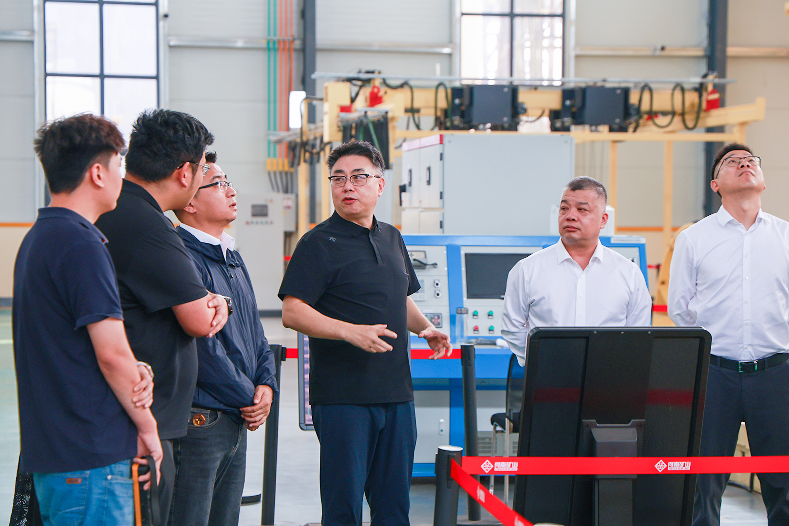 Inovance delegation discussing equipment within the Henan Mine Crane facility