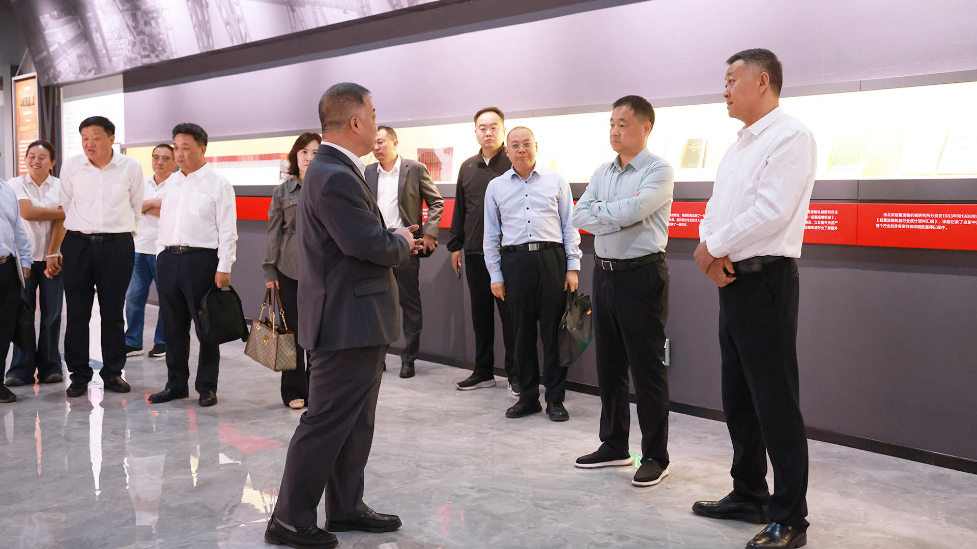 Yujian Group delegation viewing an exhibition area at Henan Mine Crane Yujian Group delegation viewing an exhibition area at Henan Mine Crane