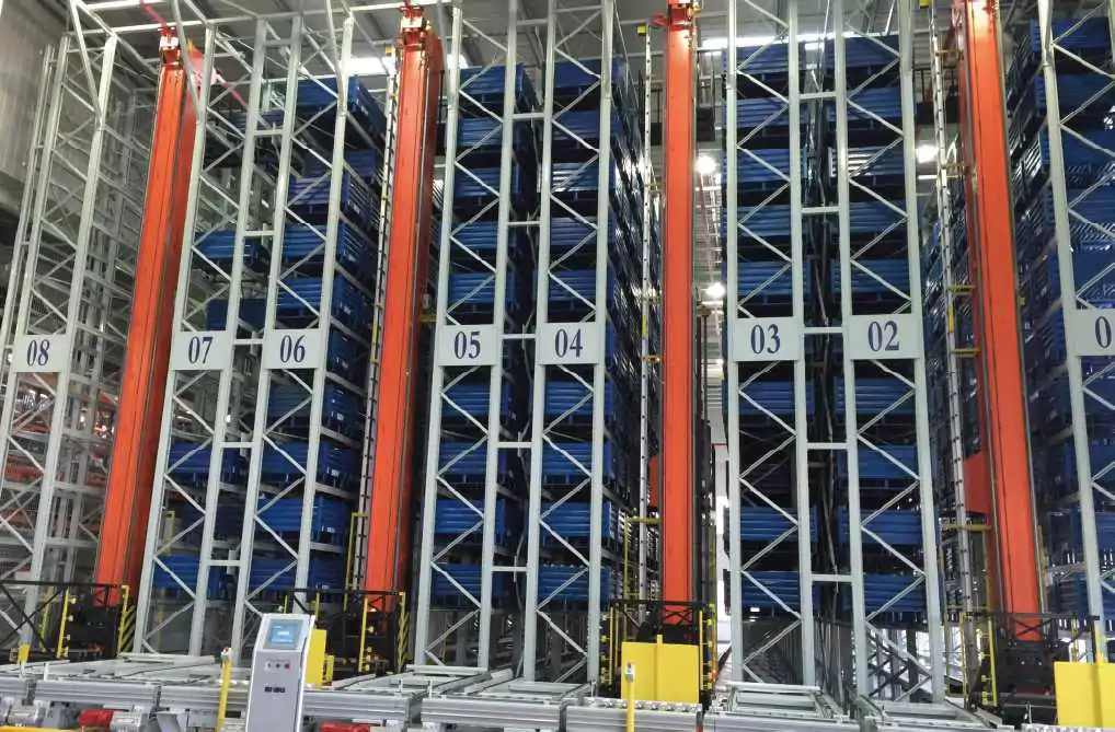 Automated warehouse stacker crane integrated with high-bay racks and material flow equipment